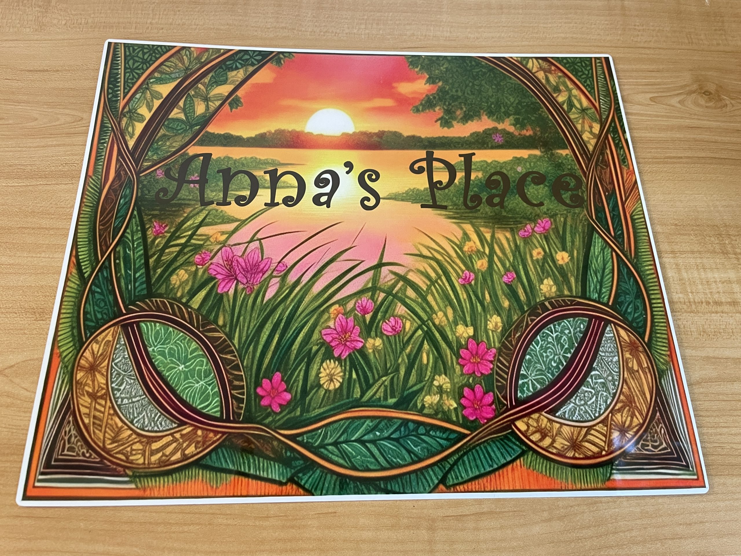 Placemat with sunset and flowers that says "Anna's Place".